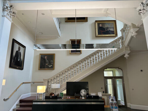 An LED pendant light fitting above a reception desk