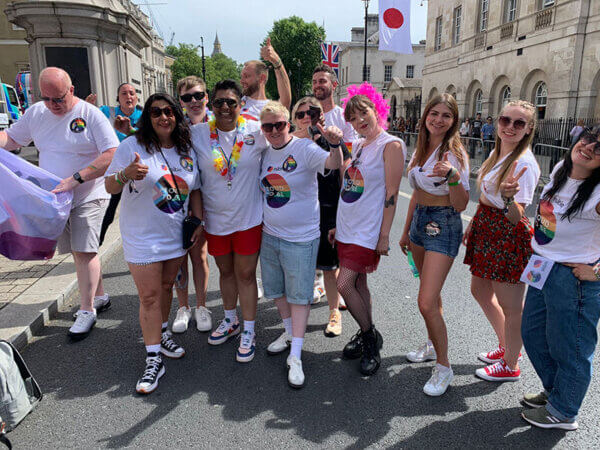 A group of Mitie colleagues at London Pride Day 2024, some wearing Mitie 'Proud to be' t-shirts