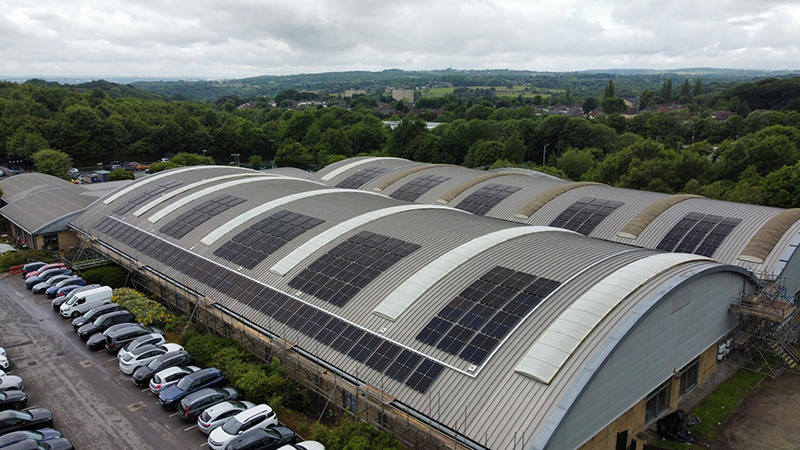 Solar panels on the curved roof of a David Lloyd leisure centre