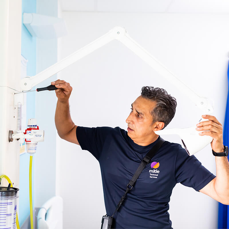 Mitie engineer fixing a lamp