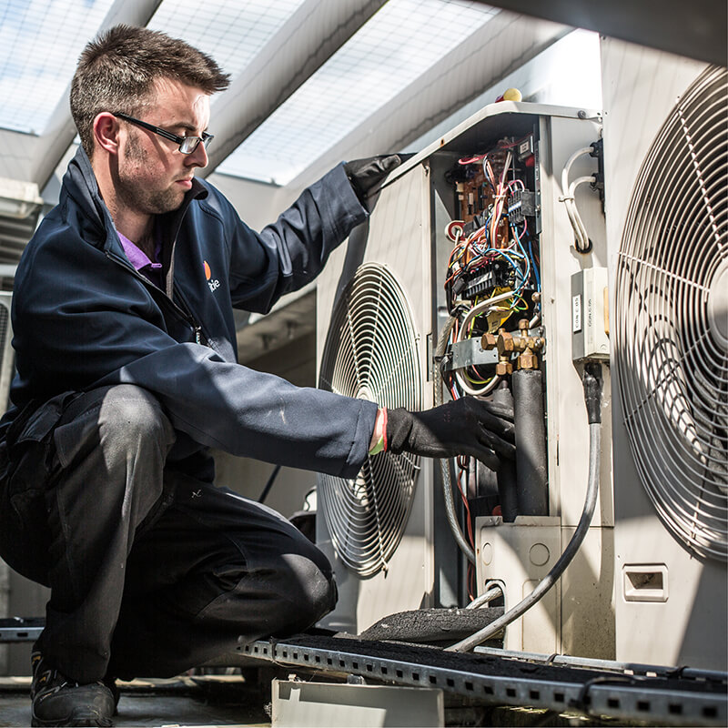 Mitie engineer working on an air con system