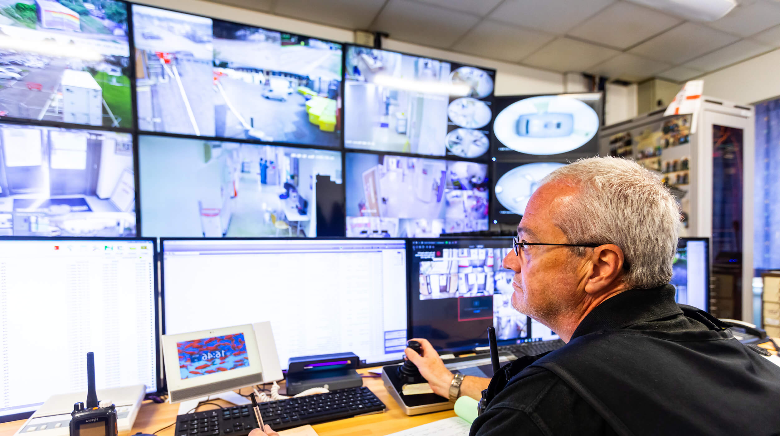 Mitie worker reviewing security camera screens